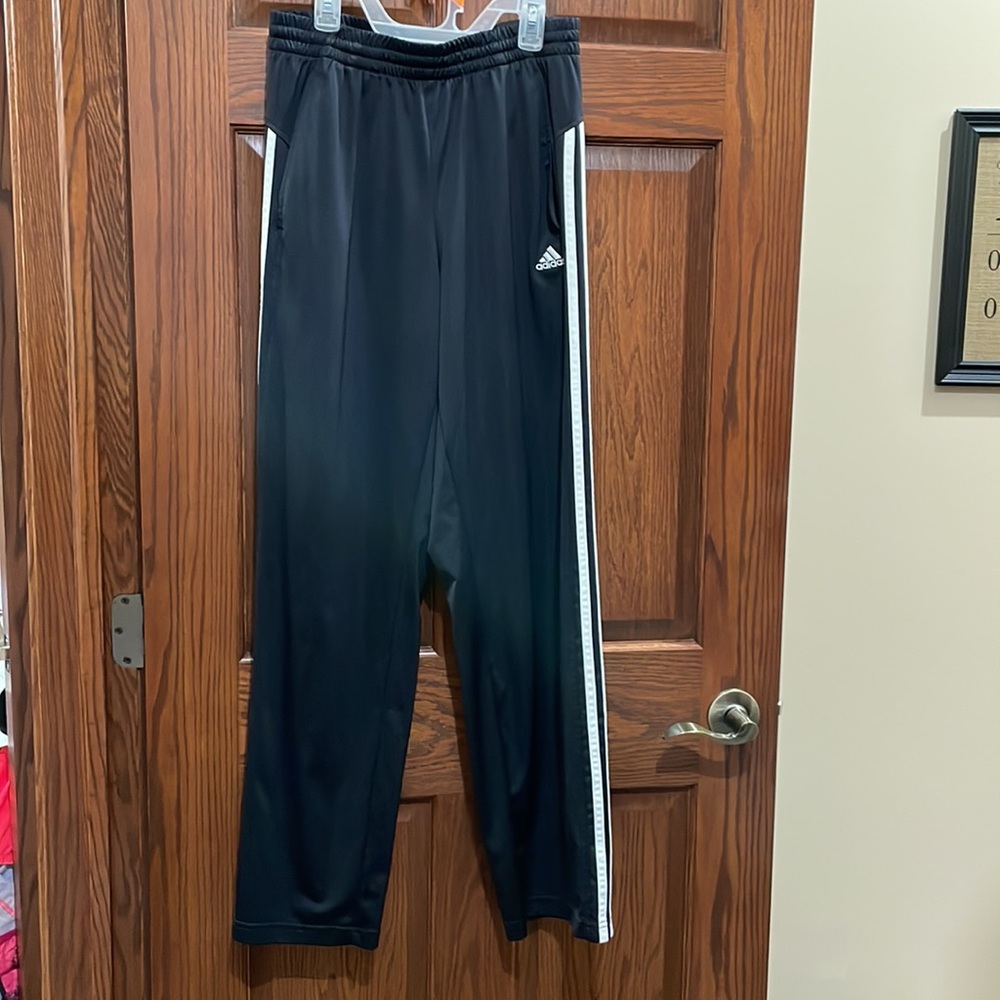 Adidas women’s black pant with white stripes. Draw string and elastic waist.